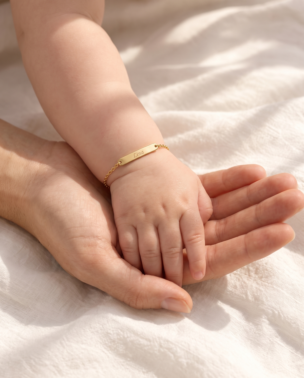 Bracelet Bébé porté, la main du bébé dans celle de sa maman