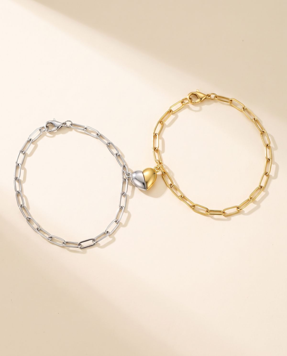 Bracelets Cœurs Aimantés : un bracelet argenté et un bracelet doré dont les moitiés de cœur se rejoignent